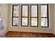 Sunroom with hardwood flooring and window views of a wooded landscape at 304 Chestatee Ct, Woodstock, GA 30188