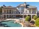 Expansive backyard featuring a pool, outdoor seating, and manicured landscaping at 300 Annelise Park Dr, Fayetteville, GA 30214