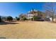 The well-maintained backyard features a sprawling lawn, landscaped gardens, and a grand home at 300 Annelise Park Dr, Fayetteville, GA 30214