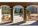 Framed view from the covered patio showcases the beautiful pool and expertly landscaped backyard at 300 Annelise Park Dr, Fayetteville, GA 30214