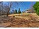 Large, beautifully landscaped backyard with lush green grass and mature trees, perfect for outdoor activities at 300 Annelise Park Dr, Fayetteville, GA 30214