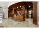 Custom-built basement bar featuring rich wood finishes, stone tile floors, and ample recessed lighting at 300 Annelise Park Dr, Fayetteville, GA 30214