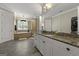 Granite countertop bathroom featuring double sinks, a laundry area, and large mirrors, offering both style and functionality at 300 Annelise Park Dr, Fayetteville, GA 30214