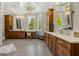 A luxurious bathroom is shown with dual vanities, windows, and a vanity table with decorative wall and ceiling accents at 300 Annelise Park Dr, Fayetteville, GA 30214