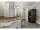Granite countertop bathroom featuring double sinks, a laundry area, and large mirrors, offering both style and functionality at 300 Annelise Park Dr, Fayetteville, GA 30214