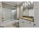 Bathroom features a shower-tub combo with a glass enclosure and a granite vanity top at 300 Annelise Park Dr, Fayetteville, GA 30214