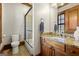 Bathroom featuring granite countertop, wood cabinets, glass shower doors, and tiled floors at 300 Annelise Park Dr, Fayetteville, GA 30214