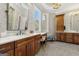 Bathroom with double vanity, wood cabinets, quartz counters, and a large window with scenic views at 300 Annelise Park Dr, Fayetteville, GA 30214