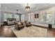 Bright bedroom featuring neutral walls, multiple windows with shutters, a ceiling fan, and two brown armchairs at 300 Annelise Park Dr, Fayetteville, GA 30214
