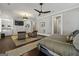 Bedroom with a ceiling fan, built-in storage, a neutral color scheme, and two brown armchairs on a rug at 300 Annelise Park Dr, Fayetteville, GA 30214