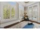 Bright bonus room features hardwood floors, neutral paint, large windows, and access to the exterior patio at 300 Annelise Park Dr, Fayetteville, GA 30214