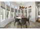 Sunlit dining area with large windows and elegant chandelier at 300 Annelise Park Dr, Fayetteville, GA 30214