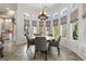 Elegant dining area with large windows, custom window treatments, and stylish light fixture at 300 Annelise Park Dr, Fayetteville, GA 30214
