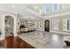 Dining room with stone floors, long table with seating for eight, and detailed trim at 300 Annelise Park Dr, Fayetteville, GA 30214