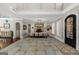 Dining room with a long dining table, stone flooring, and large windows at 300 Annelise Park Dr, Fayetteville, GA 30214
