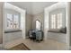 Powder blue vanity with decorative mirror and a window seat, surrounded by two bright windows at 300 Annelise Park Dr, Fayetteville, GA 30214