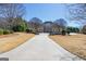 Scenic view of the home's facade, circular driveway, and well-maintained landscaping at 300 Annelise Park Dr, Fayetteville, GA 30214