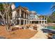 Stately home boasts an outdoor oasis with a pool, fire pit, and manicured landscape at 300 Annelise Park Dr, Fayetteville, GA 30214