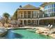 Luxury home with a stunning pool area, outdoor seating, and meticulous landscaping at 300 Annelise Park Dr, Fayetteville, GA 30214