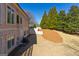 Side yard of home featuring lush landscaping, mature trees, and a well-maintained lawn at 300 Annelise Park Dr, Fayetteville, GA 30214