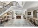 Grand foyer featuring a curved staircase, hardwood floors, and a large window with natural light at 300 Annelise Park Dr, Fayetteville, GA 30214