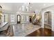 Open foyer with grand staircase, stone floors, and high ceilings, leading to other rooms at 300 Annelise Park Dr, Fayetteville, GA 30214