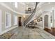 Foyer with curved staircase, stone flooring, high ceilings, and an open doorway to another room at 300 Annelise Park Dr, Fayetteville, GA 30214