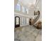 Foyer featuring curved staircase, stone flooring, a decorative front door and high ceilings at 300 Annelise Park Dr, Fayetteville, GA 30214