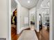 Hallway with hardwood floors, access to walk-in closet, and a glimpse of a sunlit sitting room at 300 Annelise Park Dr, Fayetteville, GA 30214