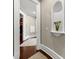 Hallway with hardwood floors, white trim, and decorative niche with a colorful glass vase at 300 Annelise Park Dr, Fayetteville, GA 30214