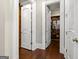 Hallway with hardwood floors and open doorways to closets and dressing areas at 300 Annelise Park Dr, Fayetteville, GA 30214
