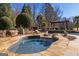 Inviting inground hot tub with stone accents surrounded by beautifully landscaped grounds at 300 Annelise Park Dr, Fayetteville, GA 30214