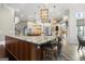 Kitchen island with seating overlooks the living areas and staircase at 300 Annelise Park Dr, Fayetteville, GA 30214
