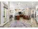 Open kitchen with expansive island, stone flooring, and coffered ceilings at 300 Annelise Park Dr, Fayetteville, GA 30214
