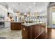 Open concept kitchen with stainless steel appliances, a large central island, and custom cabinets at 300 Annelise Park Dr, Fayetteville, GA 30214