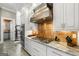 Gourmet kitchen features custom copper backsplash, range hood, stainless appliances, and marble countertops at 300 Annelise Park Dr, Fayetteville, GA 30214