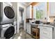 Modern laundry room featuring a work space, ample storage and stacked washer and dryer at 300 Annelise Park Dr, Fayetteville, GA 30214