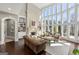 Bright living room with a stone fireplace, built-in shelving, and expansive windows at 300 Annelise Park Dr, Fayetteville, GA 30214