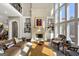 Sunlit living room with a stone fireplace, built-in shelving, and bright, open windows at 300 Annelise Park Dr, Fayetteville, GA 30214