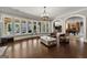 Spacious living room with hardwood floors, stylish seating, and large windows showcasing the outdoor pool at 300 Annelise Park Dr, Fayetteville, GA 30214