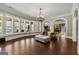 Bright living room featuring a telescope, hardwood floors, and a view of the backyard pool at 300 Annelise Park Dr, Fayetteville, GA 30214