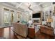 Bright living room with stone fireplace, built-in bookshelves, and seamless access to outdoor space at 300 Annelise Park Dr, Fayetteville, GA 30214