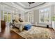 This spacious bedroom is bright and inviting, featuring hardwood floors, a large rug, and an abundance of natural light at 300 Annelise Park Dr, Fayetteville, GA 30214