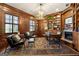 Spacious home office with wood paneling, a fireplace, built-in bookshelves, and an antler chandelier at 300 Annelise Park Dr, Fayetteville, GA 30214