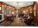 Spacious home office with wood paneling, built-in bookshelves, and a unique antler chandelier at 300 Annelise Park Dr, Fayetteville, GA 30214