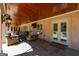 Spacious covered patio with stone floors, ceiling fans, exterior TV, and easy access to interior living spaces at 300 Annelise Park Dr, Fayetteville, GA 30214