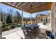 Charming patio with outdoor dining, perfect for enjoying a meal with a view of the beautiful backyard and pool at 300 Annelise Park Dr, Fayetteville, GA 30214