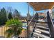 Elegant outdoor living space with stairs, overlooking a beautiful pool and lush landscaping at 300 Annelise Park Dr, Fayetteville, GA 30214