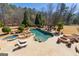 Resort-style pool with spa, waterfall feature, sun loungers, pergola, and fire pit, creating a backyard oasis at 300 Annelise Park Dr, Fayetteville, GA 30214