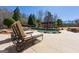 A backyard pool is surrounded by lounge chairs and lush landscaping, creating a serene outdoor living space at 300 Annelise Park Dr, Fayetteville, GA 30214